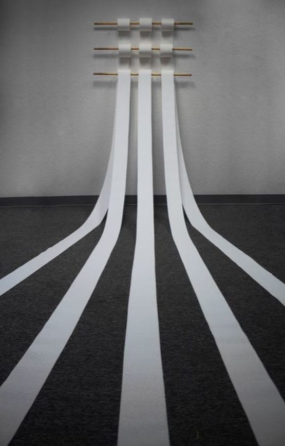 A woven tapestry installed across a bathroom