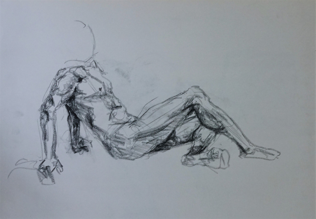 Charcoal figure drawing of a reclined man
